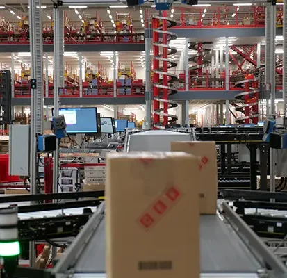 Cartons on conveyor system in warehouse Cartons on conveyor system in warehouse